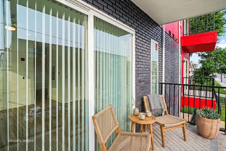Private balcony with seating beside sliding glass doors