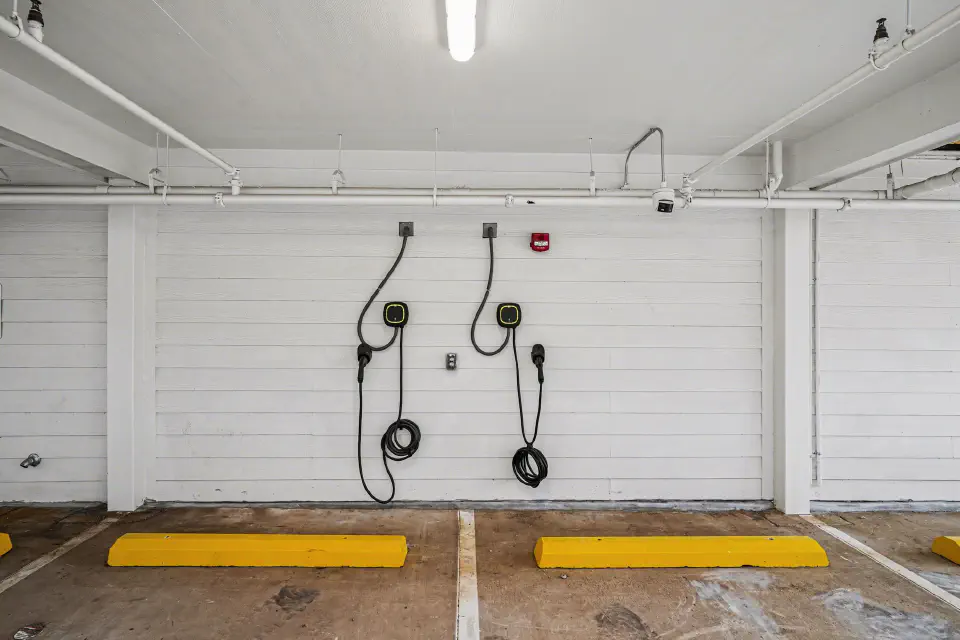 Two electric vehicle charging stations in the covered parking area
