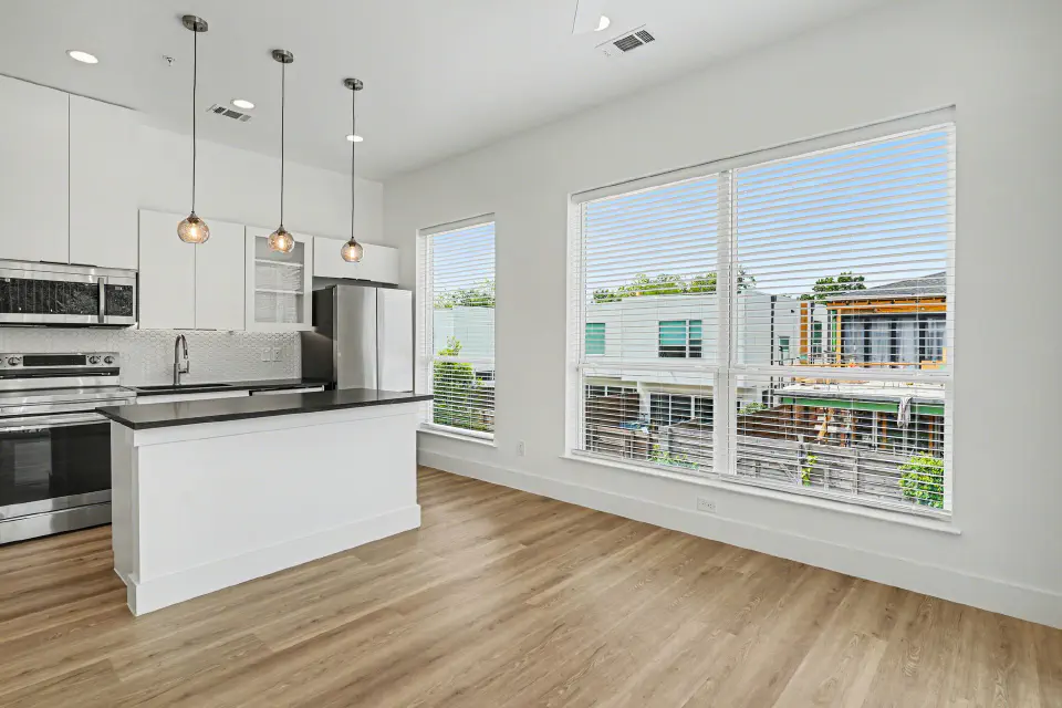 Kitchen and dining area with oversized windows and abundant natural light