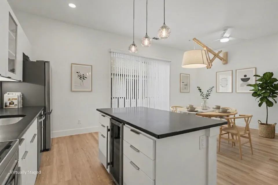 Kitchen with a large island, pendant lighting, and adjoining dining area