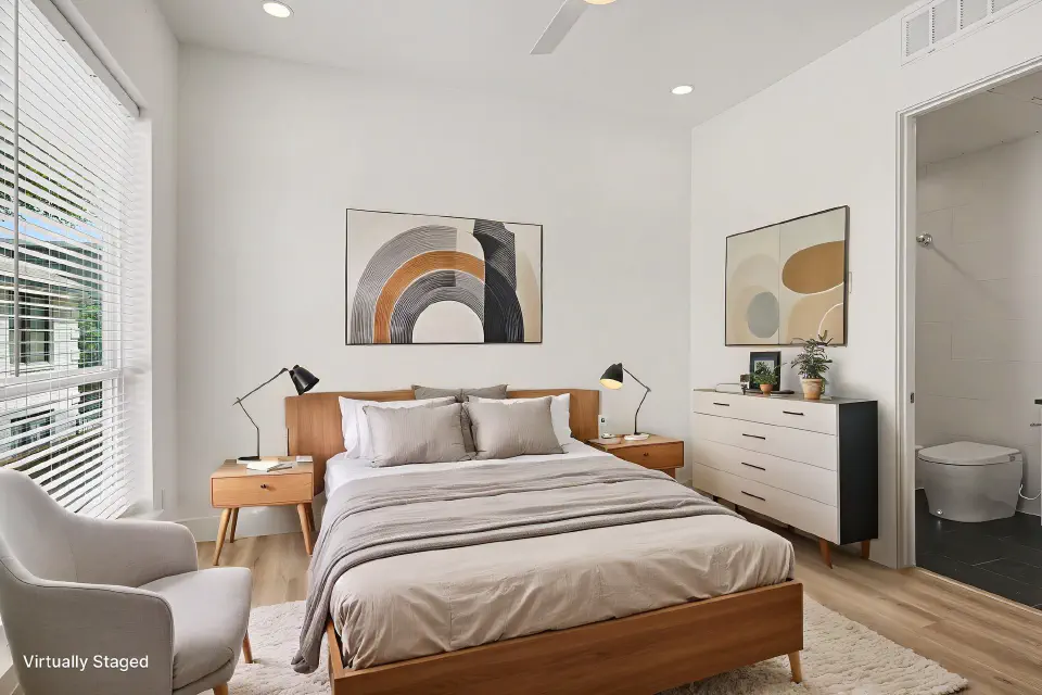 Bedroom with a large window and direct access to the bathroom